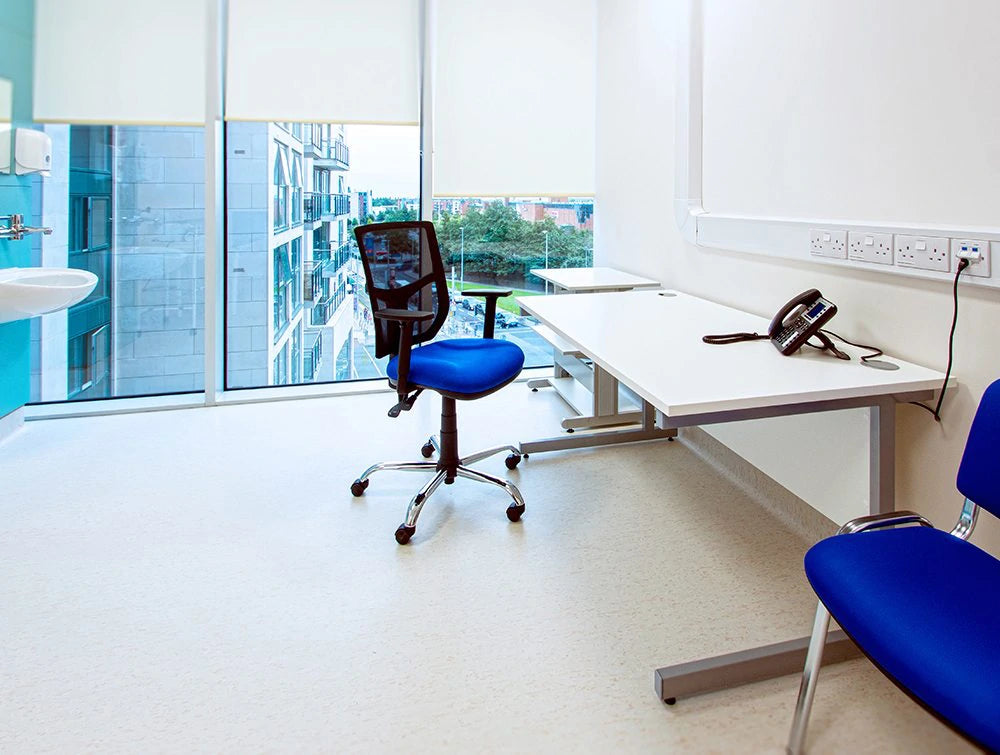 Bright Blue Chairs And Cantilever Desk In Office With Windows