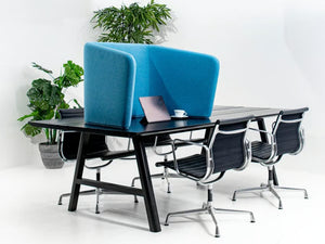 BuzziCocoon Acoustic Desk Divider in with Armchair and Indoor Plant in Office Setting