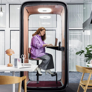 Framery One Phone Booth 2 In Pink Interior With Maroon Carpet And Pink Chair In Office Settings