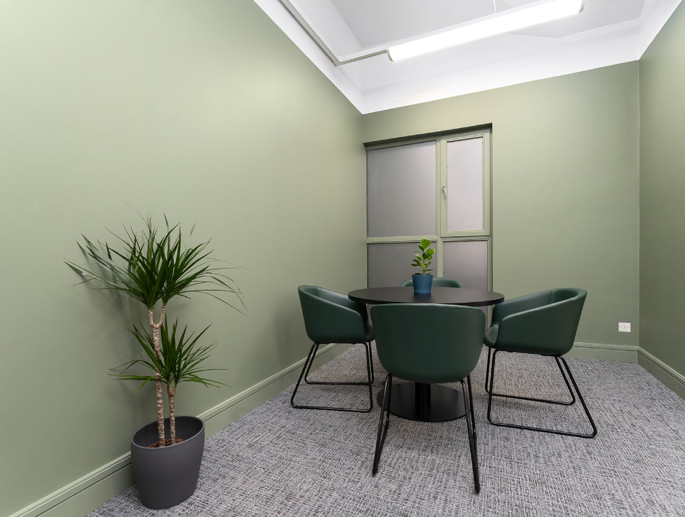 Indoor Plant With Round Table And Tub Chair In Breakout Setting