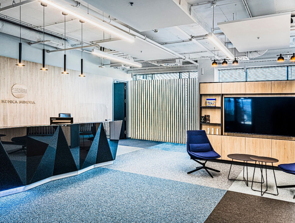 Lounge Chair Office Furniture In Blue Finish With Round Coffee Table And Wooden Media Tv Unit In Reception Setting