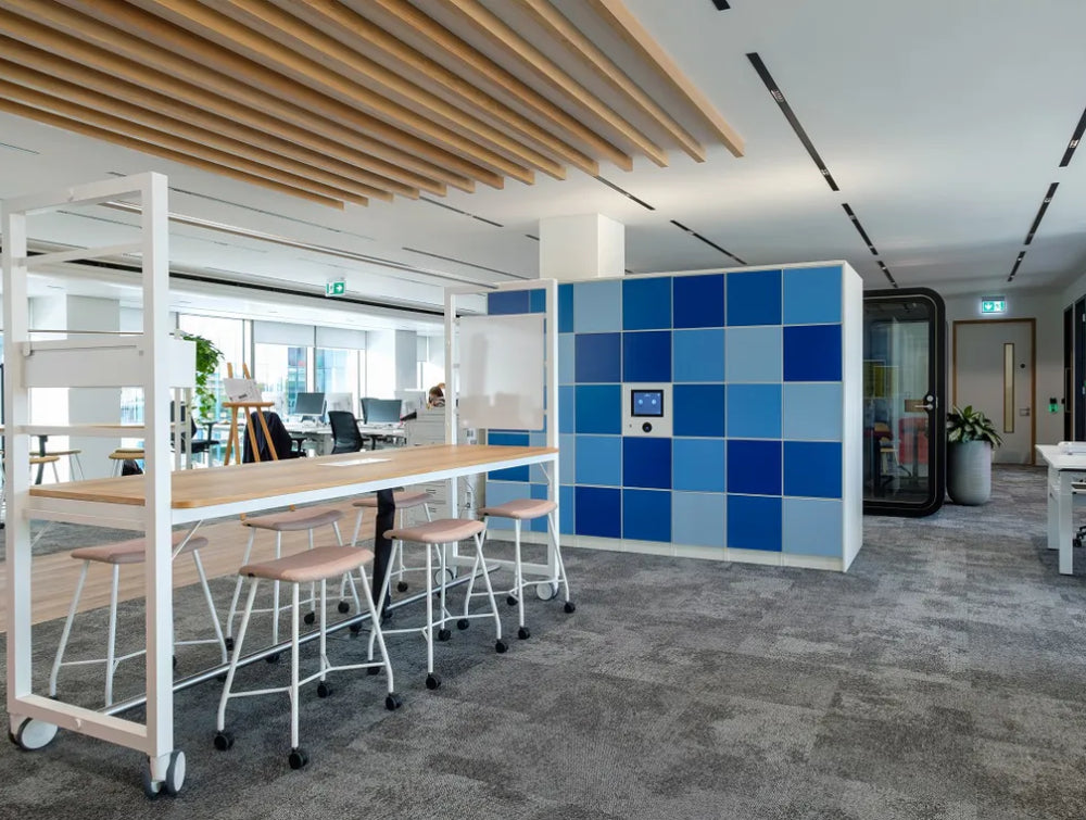 Low Stool Office Furniture In Beige Finish With Two Toned Locker And Phone Booth In Breakout Setting