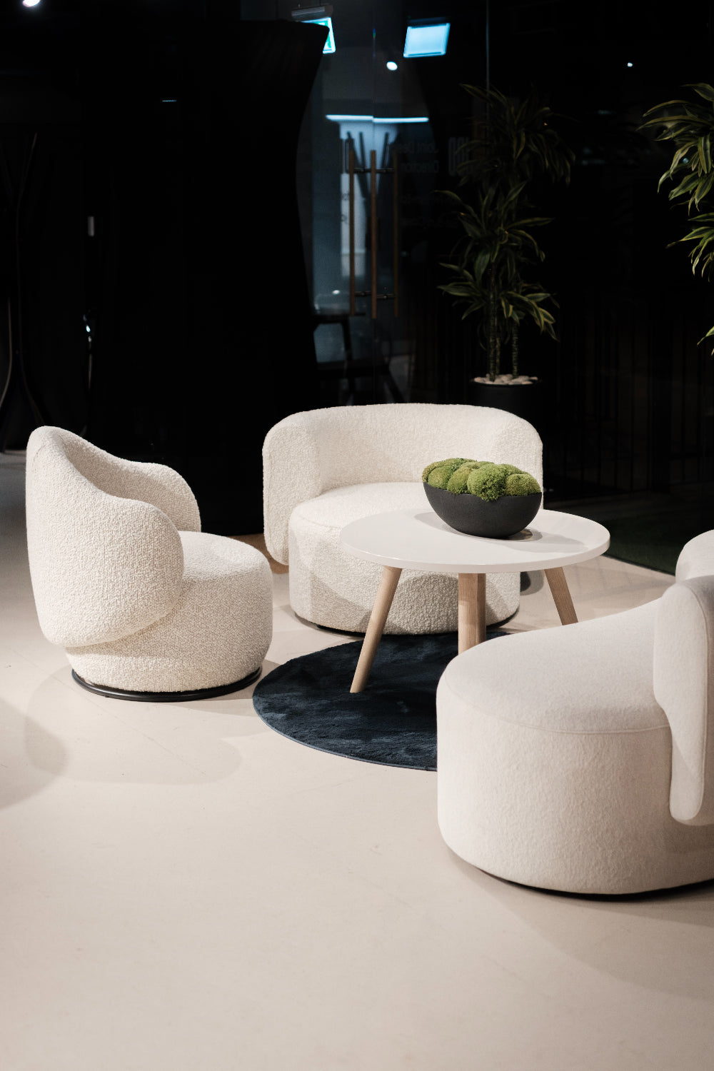 Luna Soft Seating Swivel Chair with White Round Table and White Soft Seating in Lounge Setting