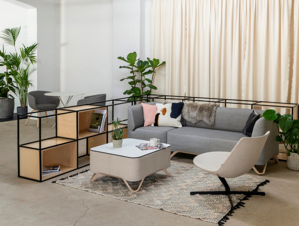 Modular Sofa Office Furniture In Grey Finish With Indoor Plant And Coffee Table In Living Room Setting