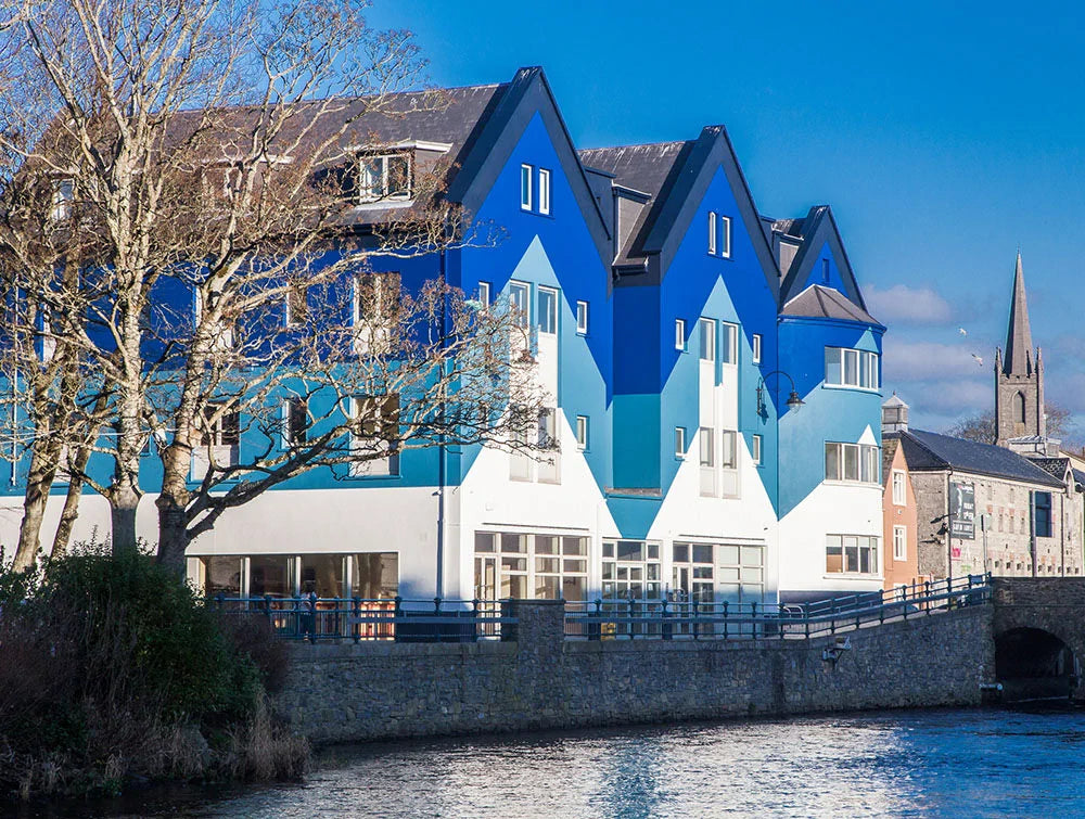 Outdoor Shot Of The Building Block With River In Foreground_Ea86Ffe4 0141 476B Aa42 9Ac3014745Ff