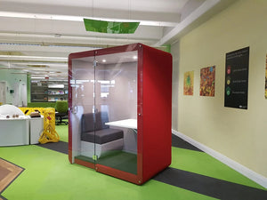 Penelope Large Workbooth Pod 1800Mm In Red Finish With Green Swivel Chair And White Bookshelves In Office Setting
