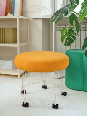 Pental Round Mobile Pouffe With Bookshelves And Indoor Plant In Living Room Setting