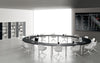Round Shaped Meeting Room Table with Wide Centre Space with Tub Chairs and Bookshelves in Meeting Room Setting