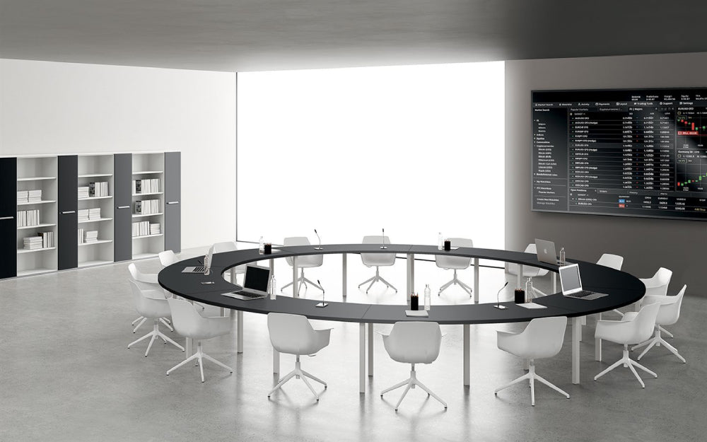 Round Shaped Meeting Room Table with Wide Centre Space with Tub Chairs and Bookshelves in Meeting Room Setting