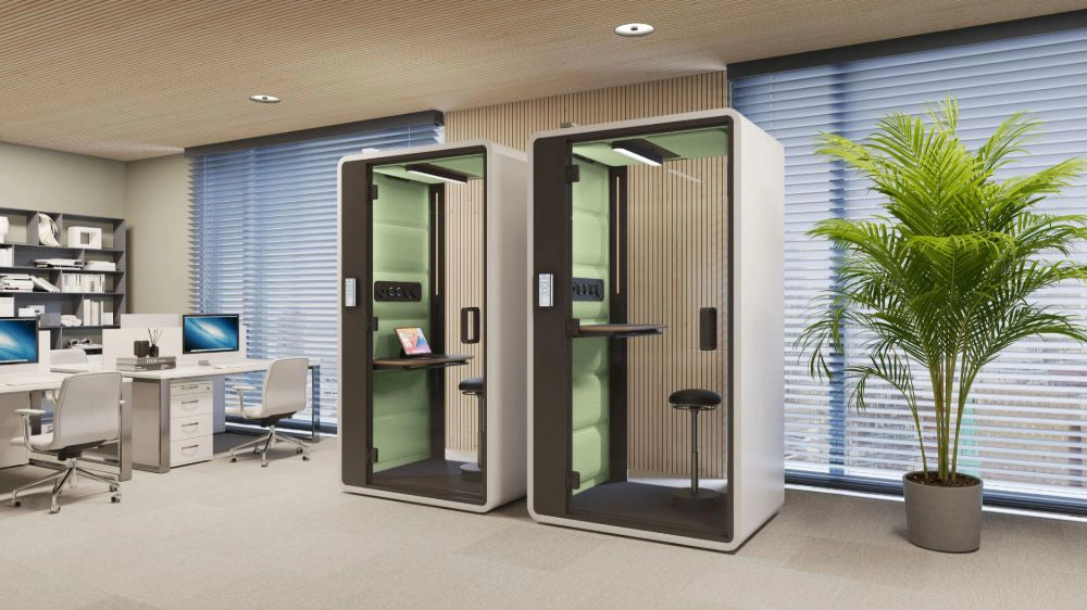 Smart Office Hush Free S Acoustic Phonebooth in White with Green Exterior with Black Top Table and Black Movement Chair in Modern Office Setting