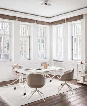 Ultra Office Chair on 4 Legged Metal Legs with Mobile Table and Bookshelf in Modern Office Setting