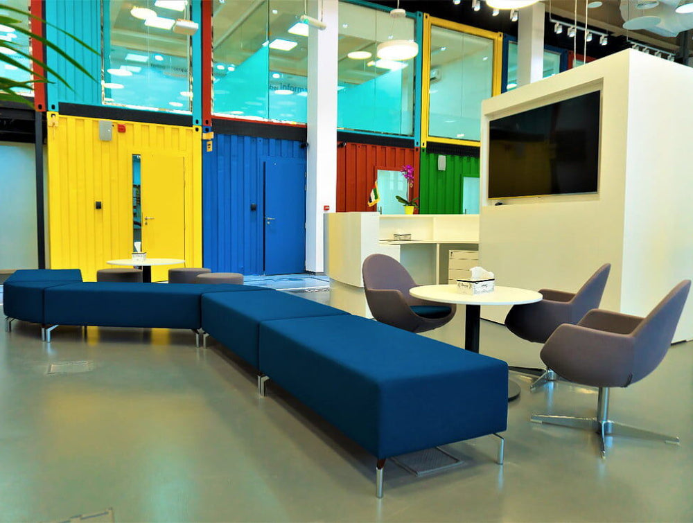 Upholstered Modular Backless Sofa Office Furniture With Lounge Chair And Round Table In Reception Setting